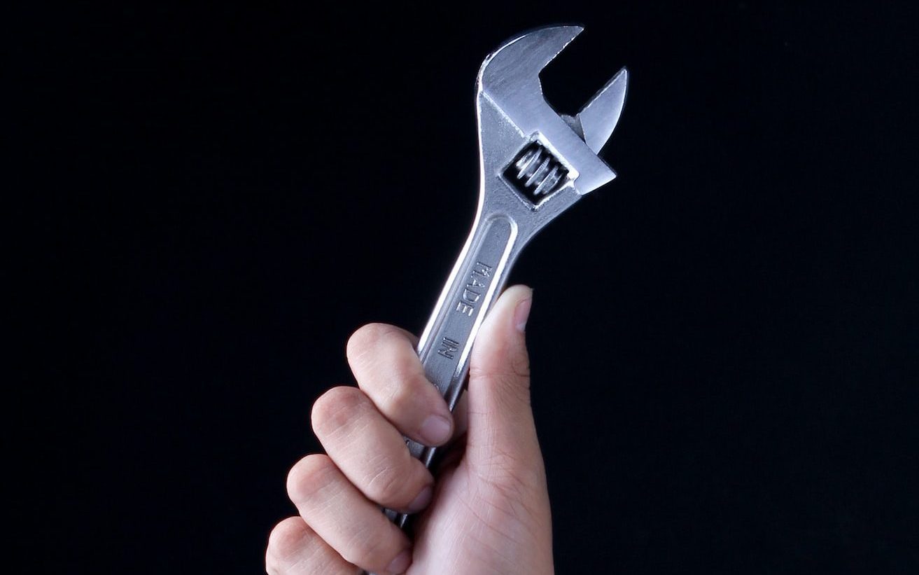 person holding gray and black metal tool