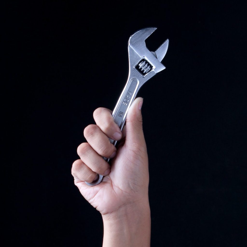 person holding gray and black metal tool